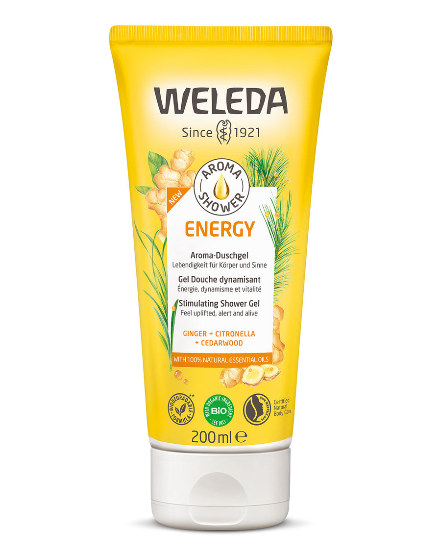 Weleda Energy Aroma Shower Gel 200ml a yellow tubes of natural ginger shower gel in an adults hand