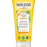 Weleda Energy Aroma Shower Gel 200ml a yellow tubes of natural ginger shower gel in an adults hand