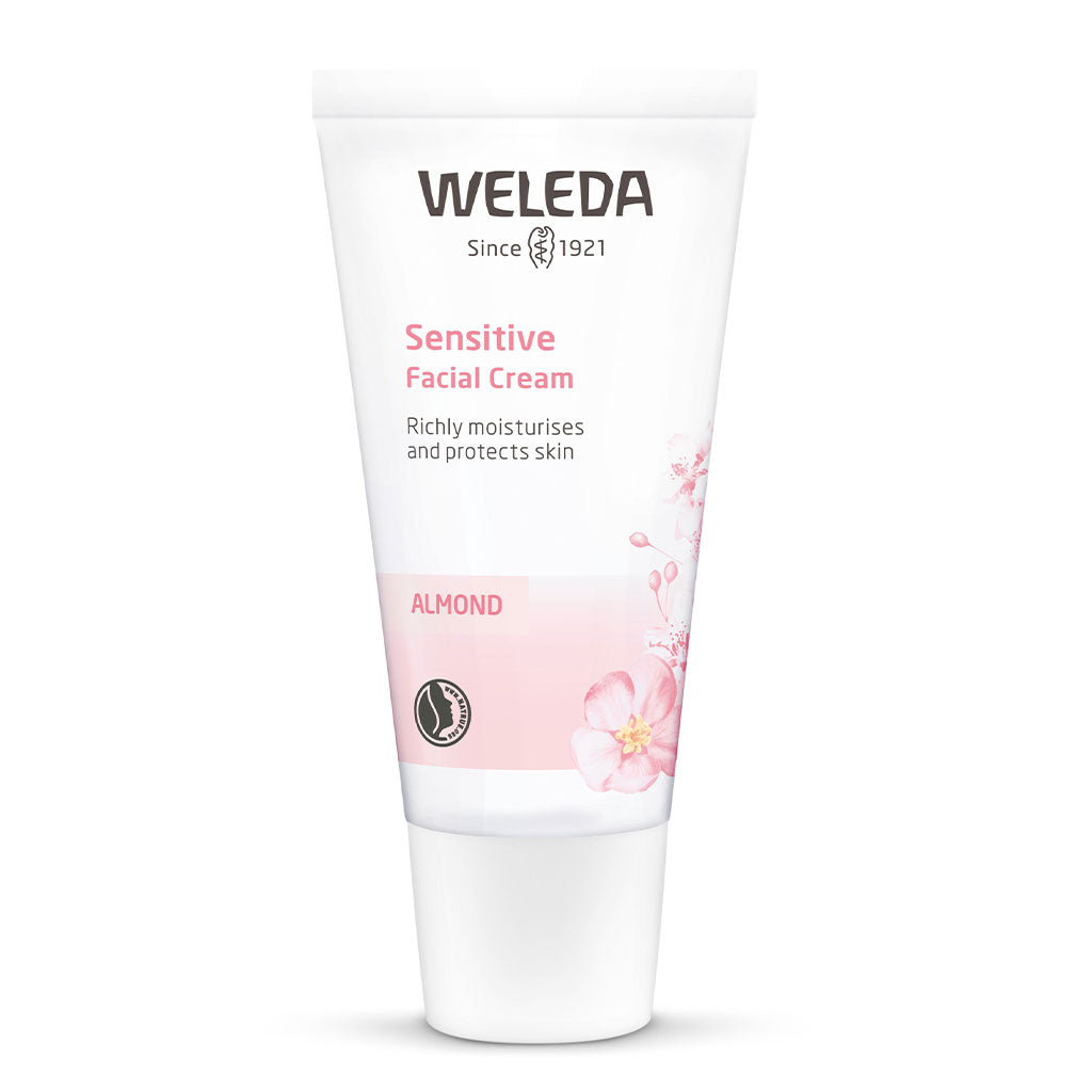 Bottle of Weleda natural almond sensitive face cream on a white background