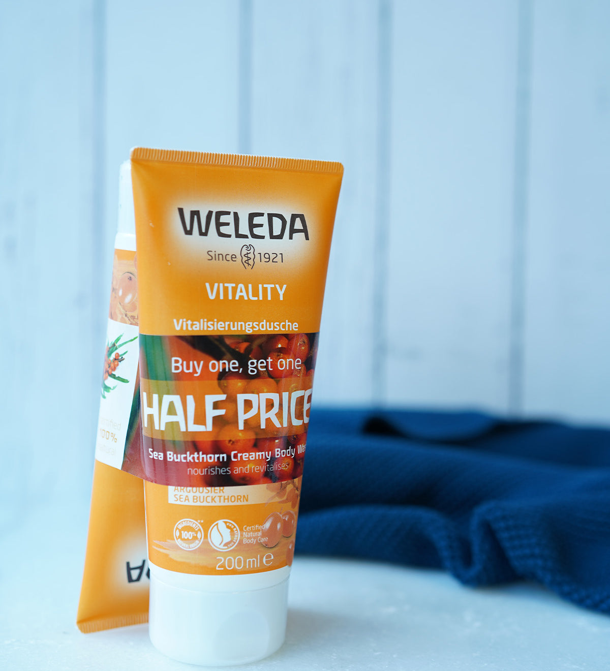 two orange tubes of natural sea buckthorn creamy body wash with  Buy 1 Get 1 Half Price band