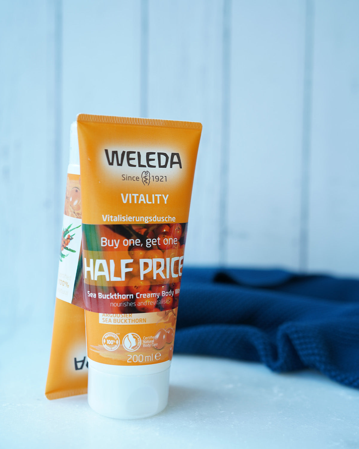 two orange tubes of natural sea buckthorn creamy body wash with  Buy 1 Get 1 Half Price band