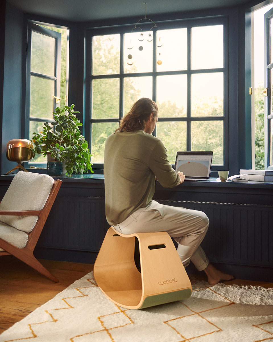 Man sat working at a windowsill