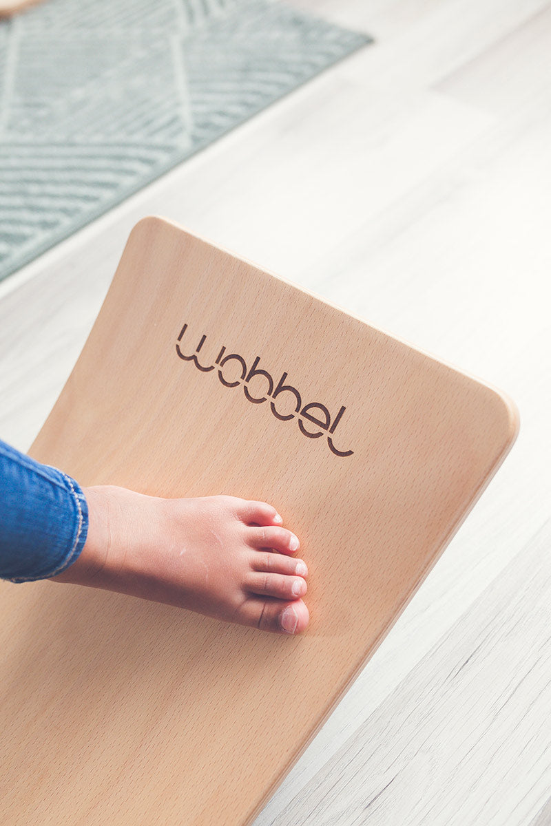 Close up of childs foot on a Wobbel Starter Beech Wood wobble board