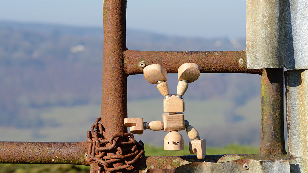 Wodibow wooden magnetic toy figure hanging onto metal