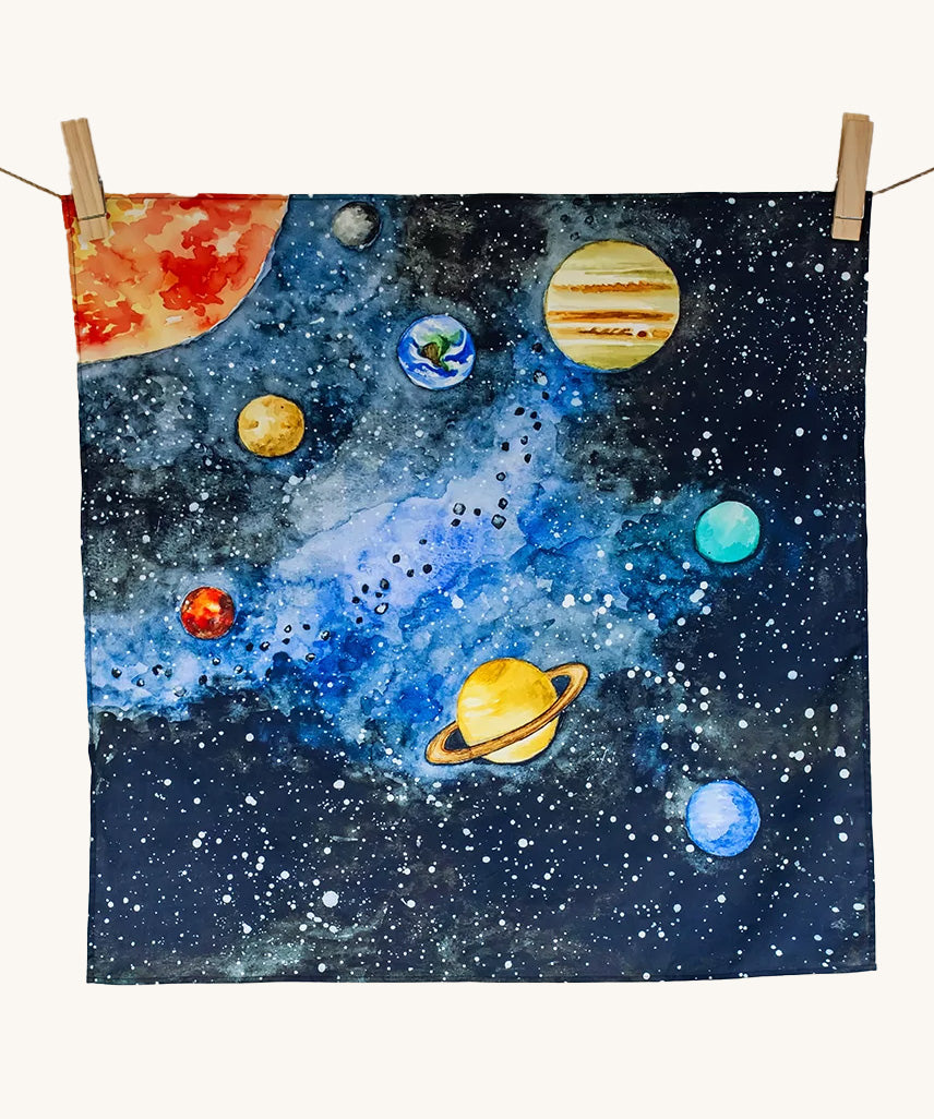 The Wonderie Giant Learning Cloth with a Solar System design hung up against a plain background. 