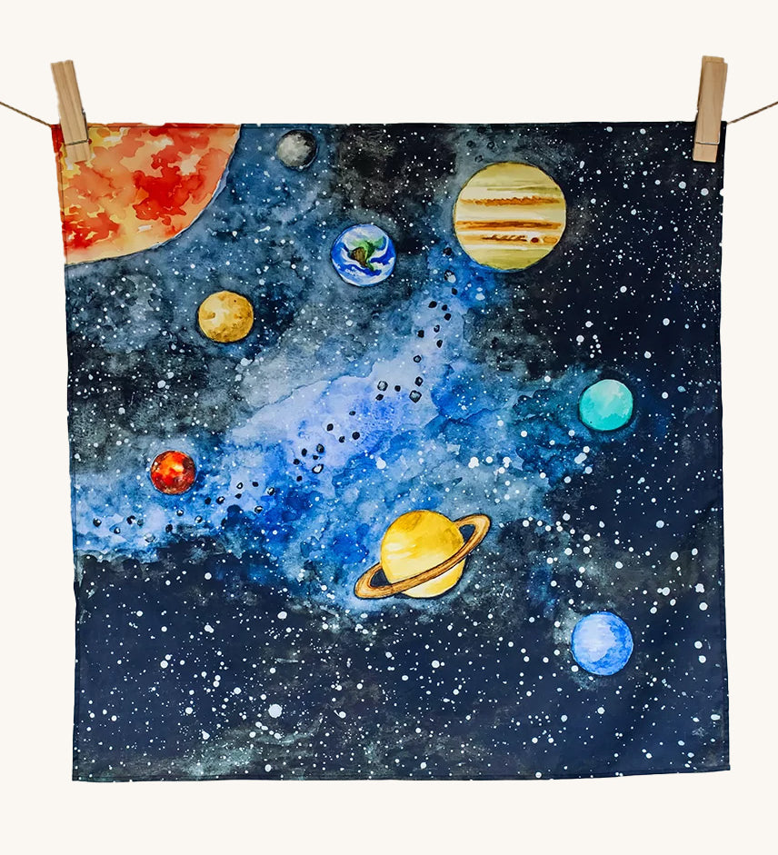 The Wonderie Giant Learning Cloth with a Solar System design hung up against a plain background. 