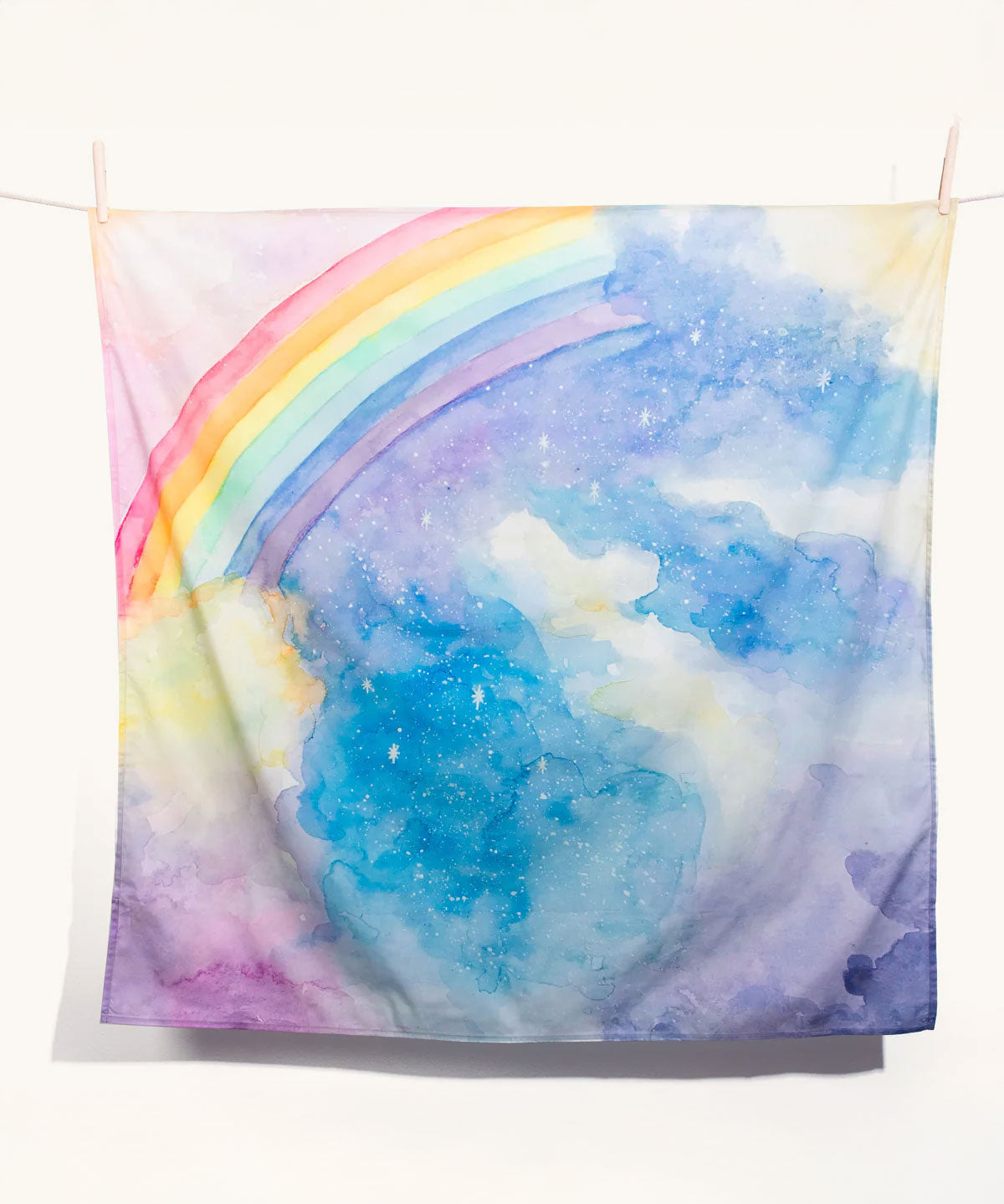 The Wonderie giant magical sky rainbow design play cloth on a plain background. 