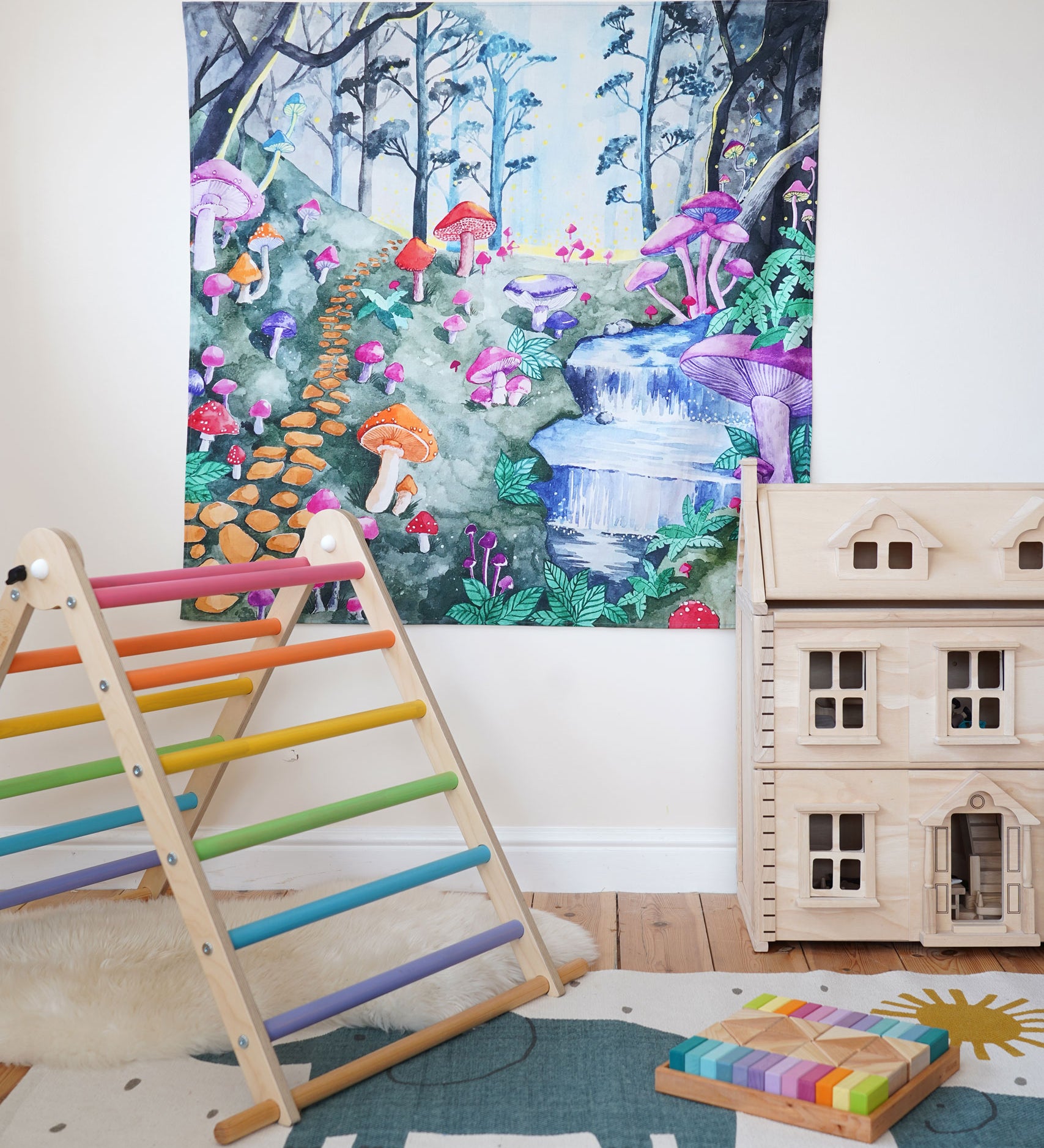 Wonderie Play Cloth with a Enchanted Toadstool Forest design hung up in a playroom surrounded by toys. 