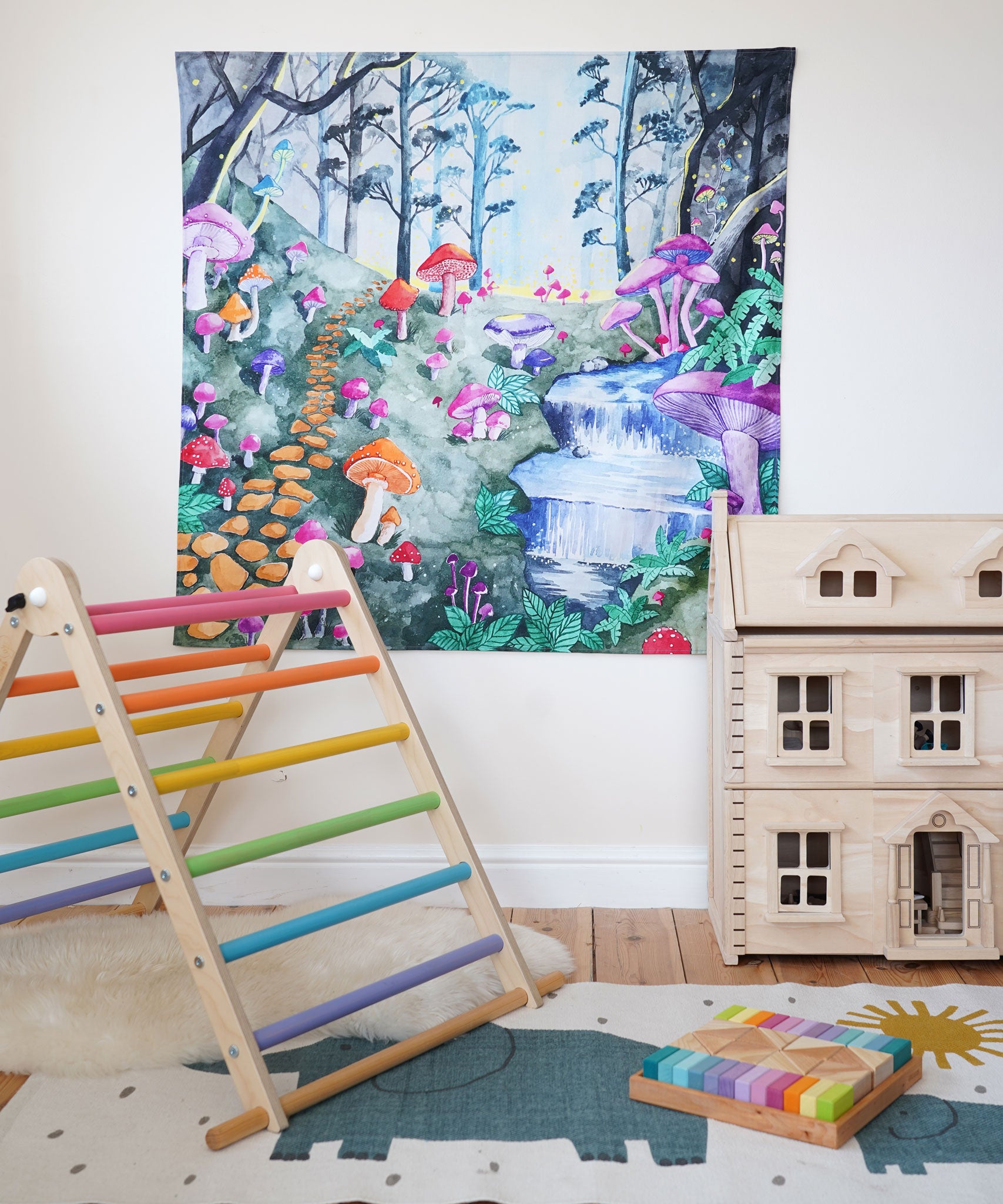 Wonderie Play Cloth with a Enchanted Toadstool Forest design hung up in a playroom surrounded by toys. 