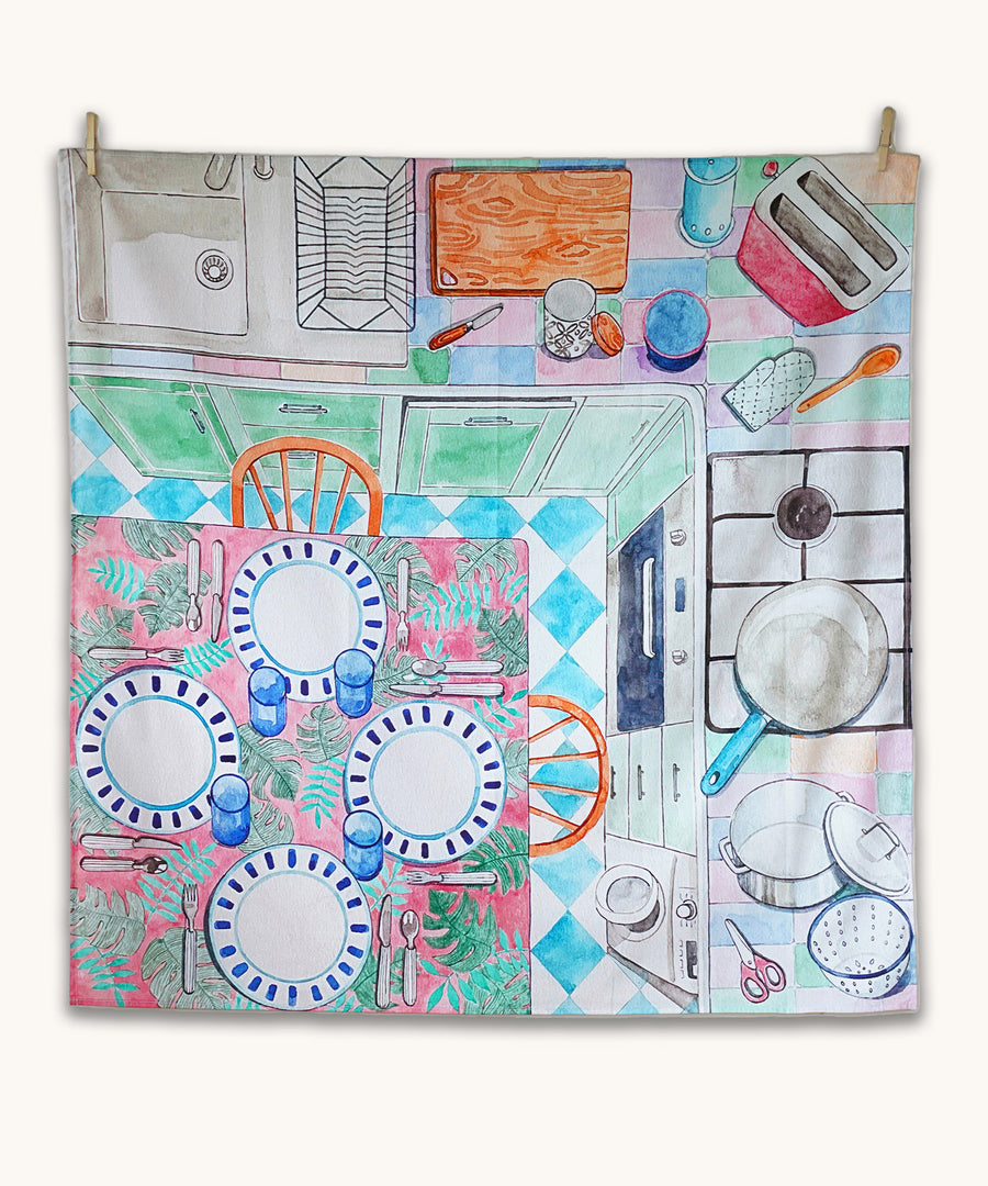 Wonderie Sensory Play Cloth - Around The Kitchen. Looking down on a busy kitchen scene, this play cloth shows a kitchen table with plates and cutlery, a cooking hob, chopping board, sink, toaster and pots and pans.