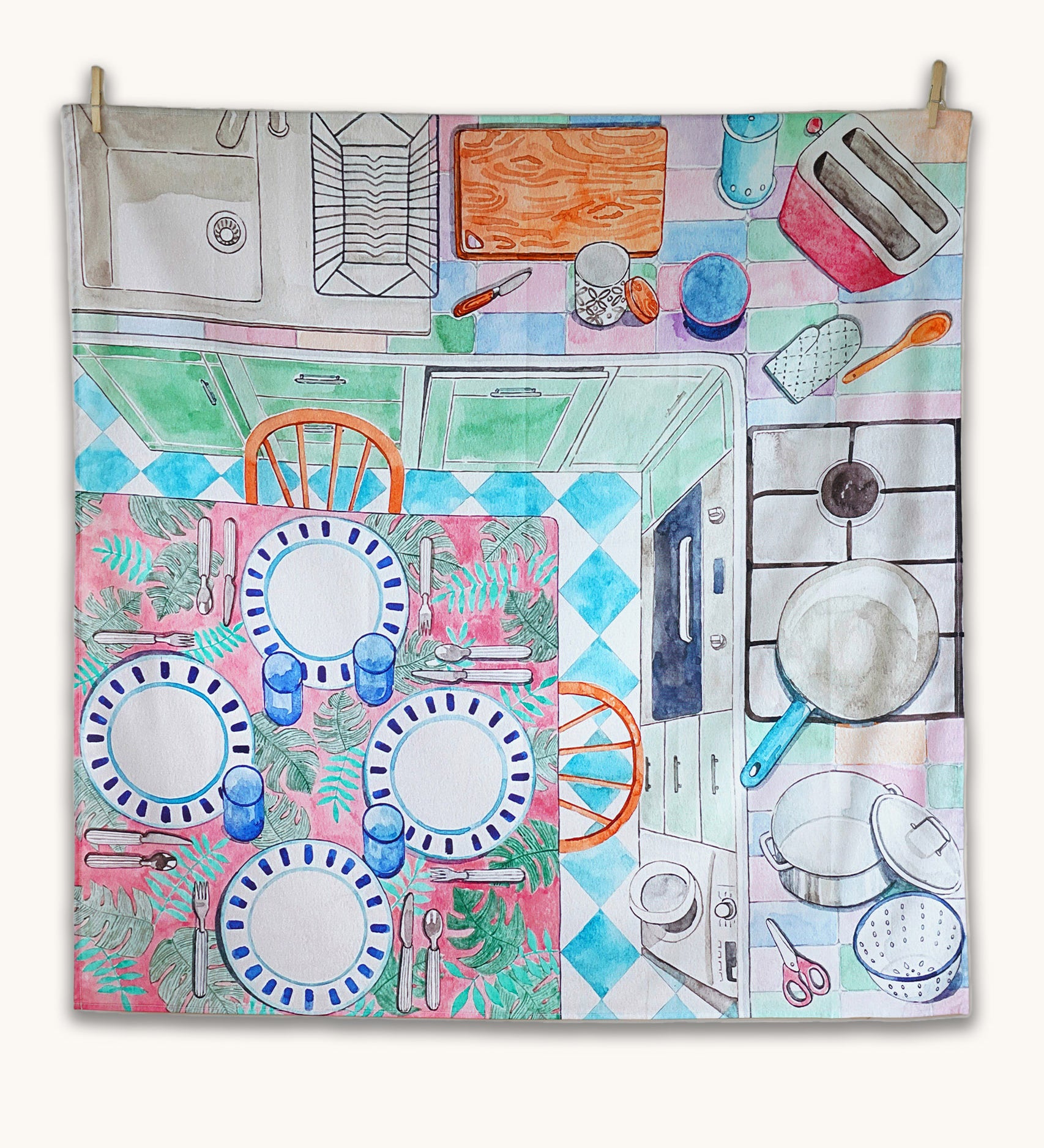 Wonderie Sensory Play Cloth - Around The Kitchen. Looking down on a busy kitchen scene, this play cloth shows a kitchen table with plates and cutlery, a cooking hob, chopping board, sink, toaster and pots and pans.