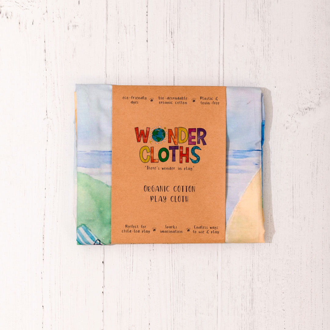 Wonderie Giant Play Cloth - A Walk Through the Seasons design folded up in a cardboard packaging sleeve