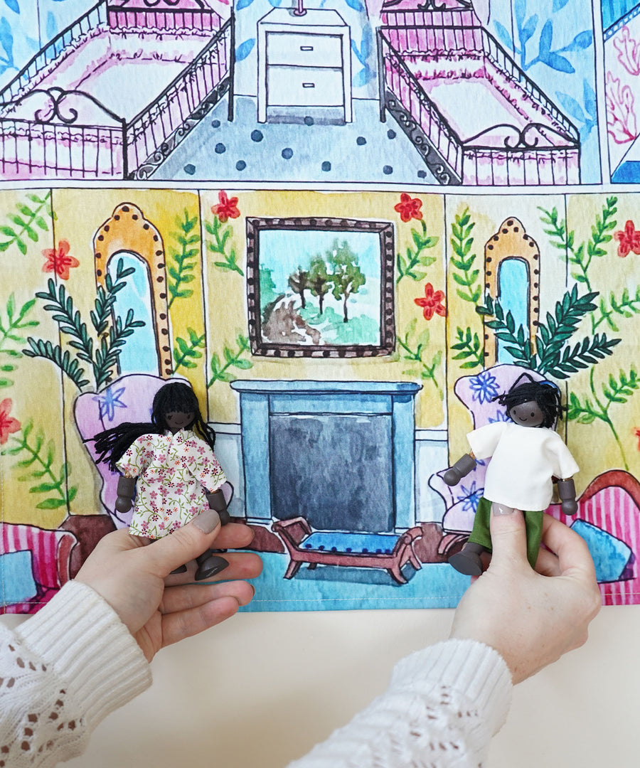 Two dolls sitting on the printed chairs in the Wonderie Sensory Play Cloth - Welcome To The Doll House.