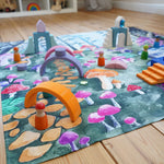 Wonderie Play Cloth with a Enchanted Toadstool Forest design in a play room covered in wooden toys and peg dolls.