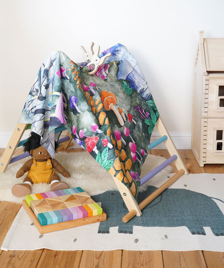 Wonderie Play Cloth with a Enchanted Toadstool Forest design being used as a cover for the TriClimb. 