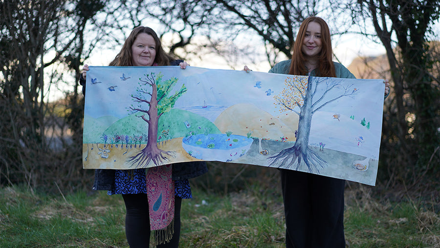 Two women holding up a Wonderie play cloth