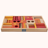 Wooden Story 54 Warm Blocks in Tray on a plain background. The photo is taken at an angle wit the side of the tray showing. The Wooden Story logo can be seen on the side of the tray. 