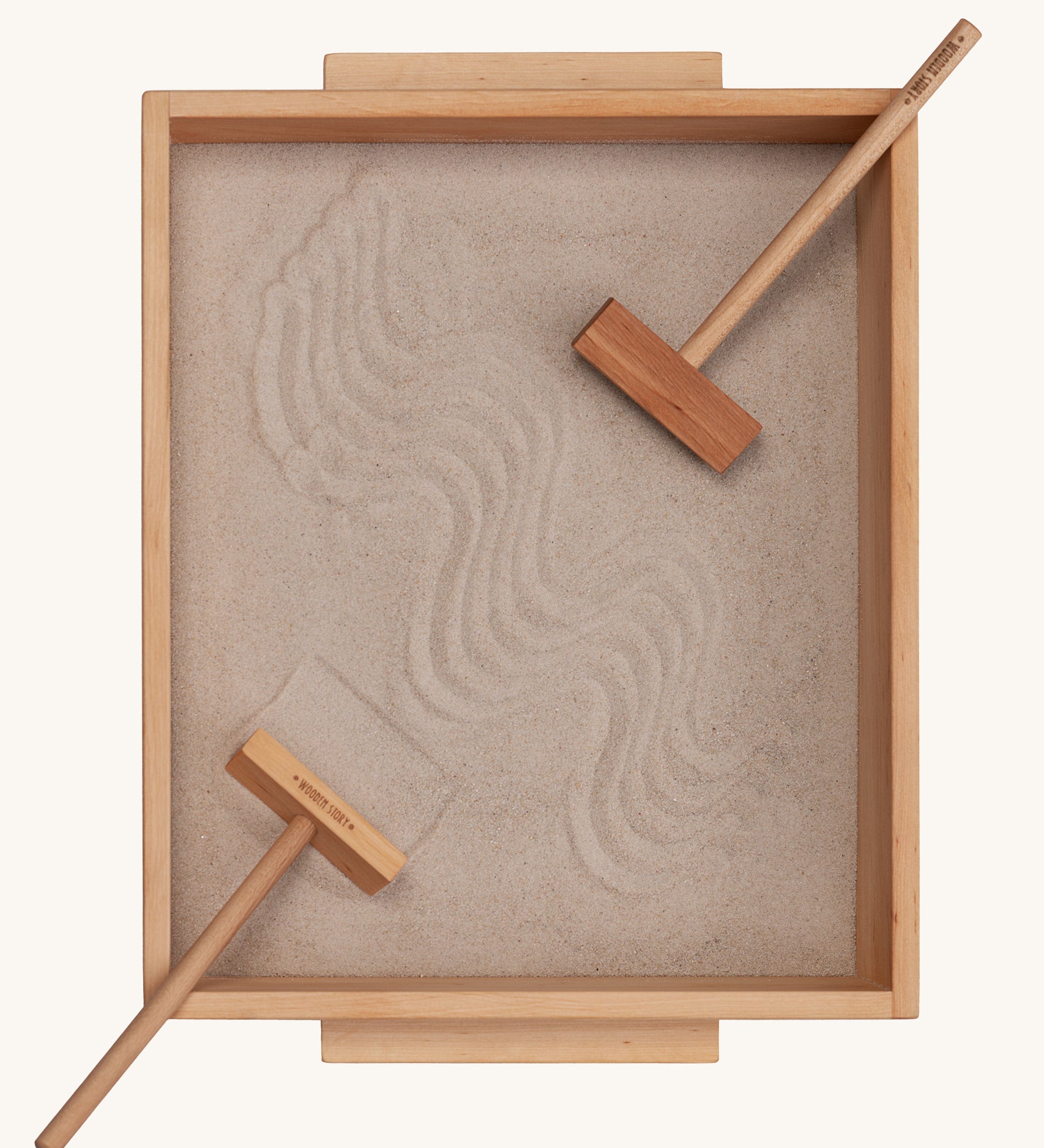 Wooden Story Montessori Sand Tray and Accessories shown on a plain background. The sand is in the tray with the tools. 