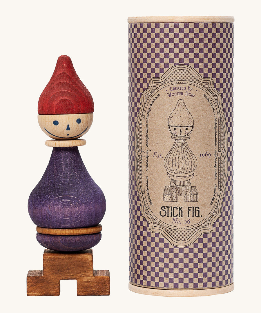 Wooden Story Stacking Toy Stick Figure - No6 next to its decorative cardboard tube with a wooden lid.