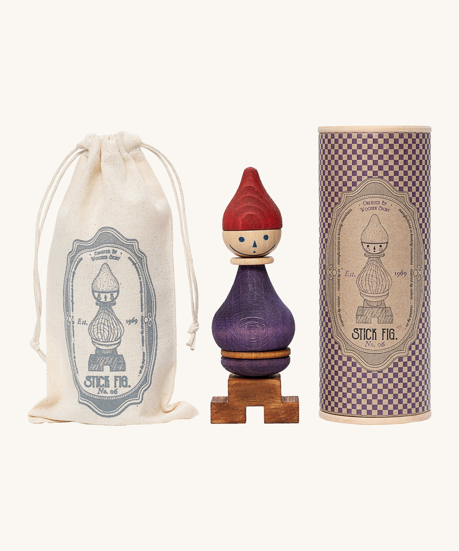 Wooden Story Stacking Toy Stick Figure - No6 next to its cotton storage bag and decorative cardboard tube. 