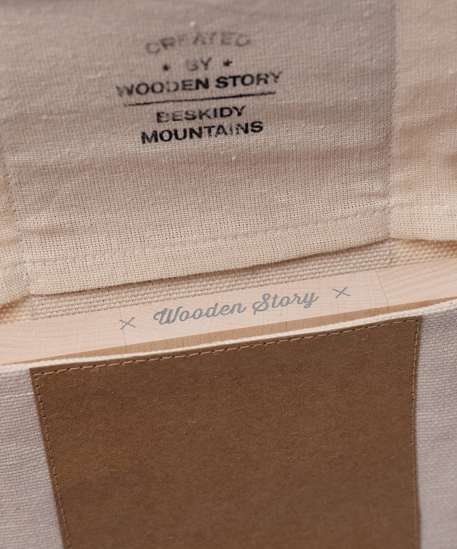 A close up of the opening on the canvas pouch packaging that the Wooden Story Number Tracking Board comes in. 