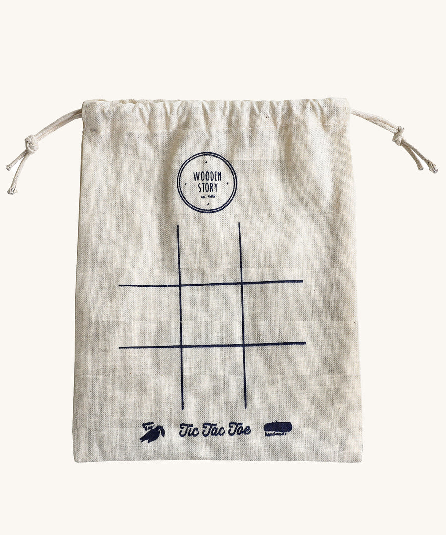 The drawstring bag that comes with the Wooden Story Tic Tac Toe set. A simple 9 space grid has been printed on the front of the bag.