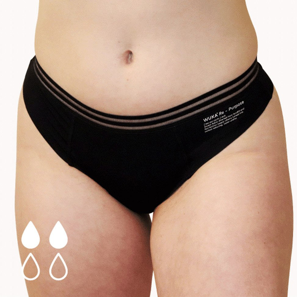 Close up of a woman stood on a white background wearing the WUKA eco-friendly re-purpose brazilian thong period pants