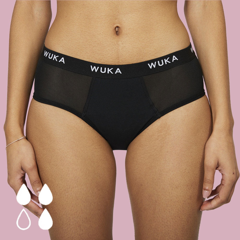 Close up of woman wearing the WUKA reusable ultimate midi brief period pants on a white background